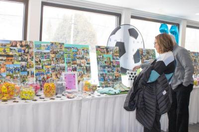Hundreds of photos of Madelyn lined the tables at the Century House. Photos by Grace Roche