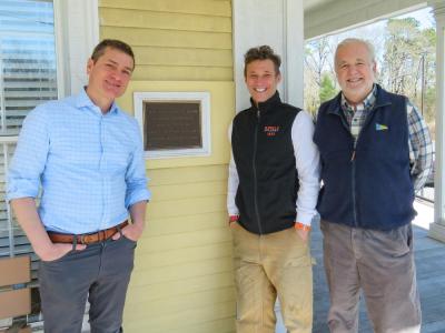 From left: Joshua Fischer, Gerry Riker and Will Tifft stand outside the Captain Hadley House. Photos by Grace Roche