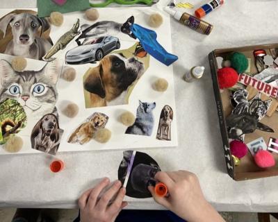 A student crafts a collage featuring animals and a car during a session at the Marion Art Center. Photo source: Marion Art Center