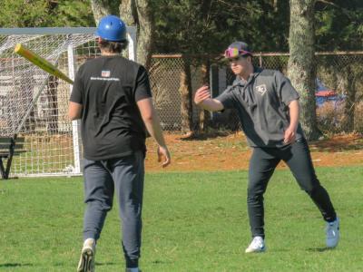 Aiden Deree, right, tosses a soccer ball during a hitting drill. 