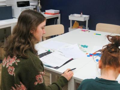 Penelope Angeley guides her student Olivia through a reading lesson. 