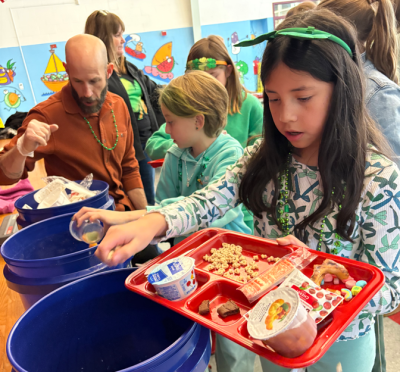 An Old Hammondtown School student sorts through food waste. Photo source: Marion Institute