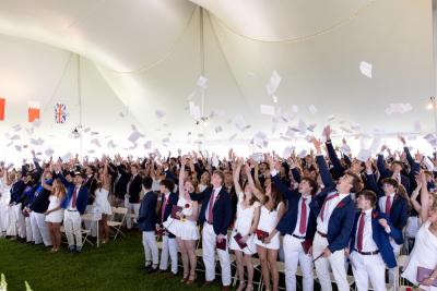 Graduates toss their commencement programs in the air at graduation on Friday, May 22. Photos source: Lawrence Films