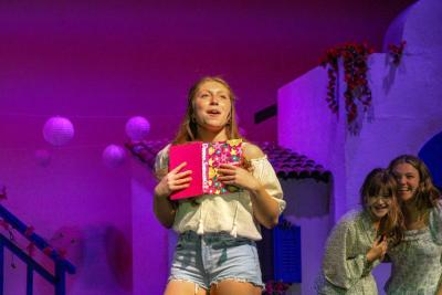 Sophie Sheridan, played by Fiona Roveda, sings during the opening scene of the show. 