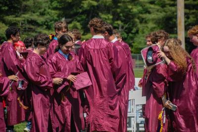 Students embrace and celebrate after the ceremony. 
