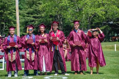 Graduates pose for a picture after receiving their diplomas. 
