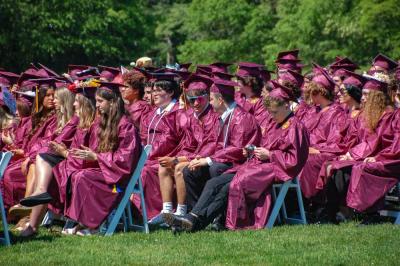 Rows of graduates wait for their names to be called. 