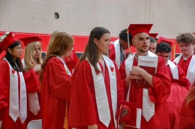 Graduated students head out of the gym. 