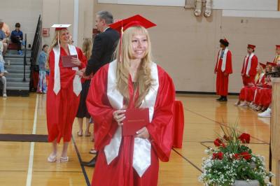 Students shake hands with school administrators and pose for photos during the ceremony. 
