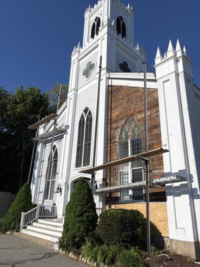 Scaffolding rises above the Rochester Church Green exposing the original 1837 rough- cut sheathing boards.