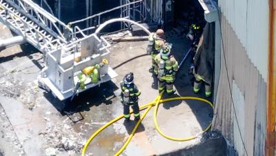 Firefighters man the hoses. 