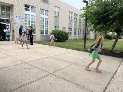 Kids run out of Sippican School after an early dismissal. 