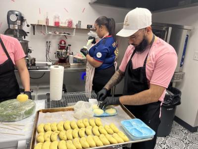 DeAndre Gibau pries chilled pastries from a mold. 