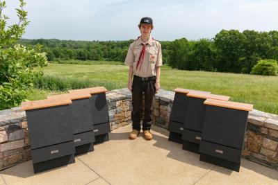 Eddie Brown poses with some of the bat houses he built. Photos source: Rochester Troop 31