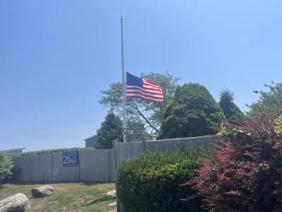 The Harbor Beach flag flies at half-mast in honor of James Rizza. Photo by Grace Roche