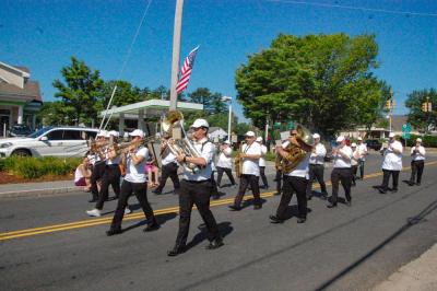 The Marion Concert Band marches down Route 6. 
