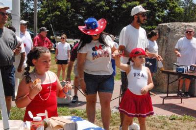 Attendees in patriotic garb ring bells at the Rochester event. 