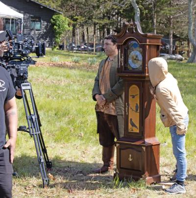 Salustiano Berrios as Michael Wainer with the grandfather clock.