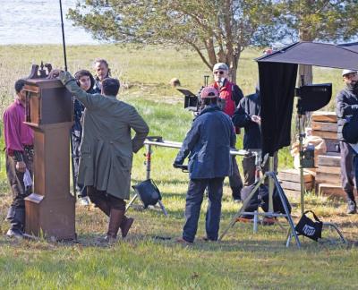 Crew members go over a scene on the bank of Slocums River.