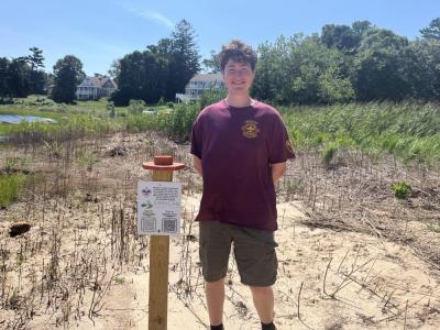 Iain McManus stands next to one of his photo posts at Brainard Marsh. Photos by Grace Roche