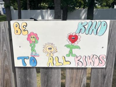 One sign features smiling flowers with a kind message. 