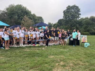 The Eitas family, surrounded by Madelyn's friends and soccer community, cut a ribbon to open Maddie's Circle at the Mariner Youth Soccer Complex on Friday, Aug. 28. Photos by Grace Roche