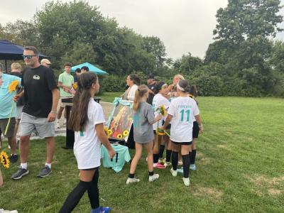 Becky Eitas embraces some of her daughter's former teammates. 