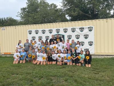 Madelyn's former teammates smile for a photo with her family.