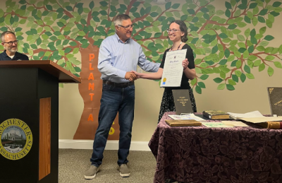 Senator Michael Rodrigues presents a certificate to Cardoso from the state senate. Photo by Tanvi Kulkarni