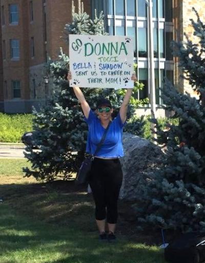 Laura Keegan cheers for Tocci along the course near Boston College in 2017. 