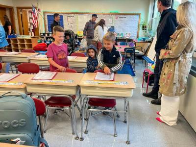 Students find their new desks. 