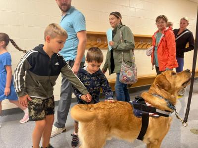 Students pet Norman. 