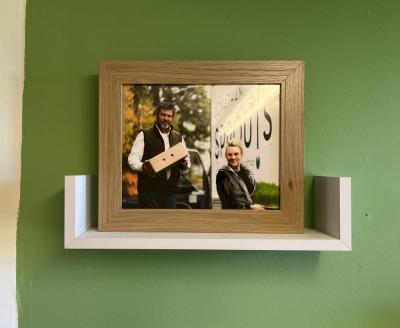 Reilley displays a photo of her former business partner Rich Wolfe in her office at the farm. 