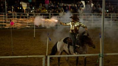 A rider shoots a gun during the Sept. 19 rodeo. Photo by Benjamin Martins