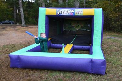Cash Elder swinging at the inflatable tee ball game.