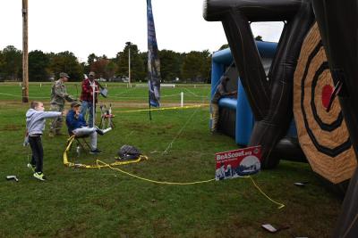 Theodore Patten playing at the inflatable axe throwing game.