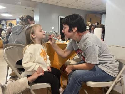Morgan Suddard, 4, get her face painted during the event. 