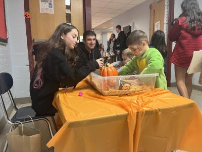 Kids play in a harvest-themed sensory bin. 