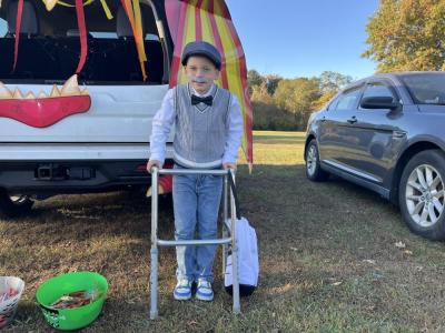 Robert Caldas, 7, leans on his walker in his old man costume. 