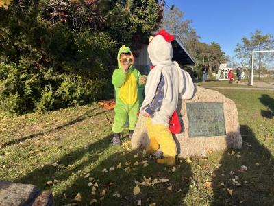 3-year olds Calvin Swegles, the dinosaur on the left, and Henry Kearns, the chicken, play together at the trunk or treat. 