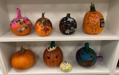 Decorate a pumpkin for a spooky contest.