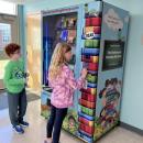 Eli Linane, left, and Cora McNeany use their tokens to buy a book from the vending machine at Rochester Memorial School. Photos courtesy: Rochester Memorial School.