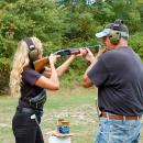 Particpant lines up to shoot a clay pidgeon at the shotgun range. 