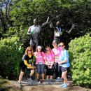 (From left to right) Sue Smith, Kara Pernice, Sue Kindregan, Deborah (Pernice) Duffy and Donna Tocci stop at the Johnny Kelley statute in Newton during their first year walking as a team. 