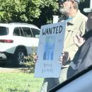A protestor at the Mattapoisett "No Kings" rally holds a violent sign, leading to a police investigation. Source: Paul Criscuolo