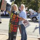 Rosanne Sinderman of Rochester and Stacy Latt Savage of Mattapoisett protest together along County Road.