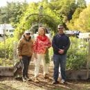 (left to right) Brooke Johnson, Barbie Burr and Mike Healey stand in front of the garden beds.
