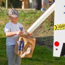 A Yankee baseball player recieves candy from the Public Works candy tube. A Yankee baseball player recieves candy from the Public Works candy tube.