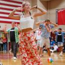 Seniors smile through their dance infront of the whole school and parent spectators.