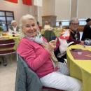 Another winner of a raffle is pleased to share her prize.